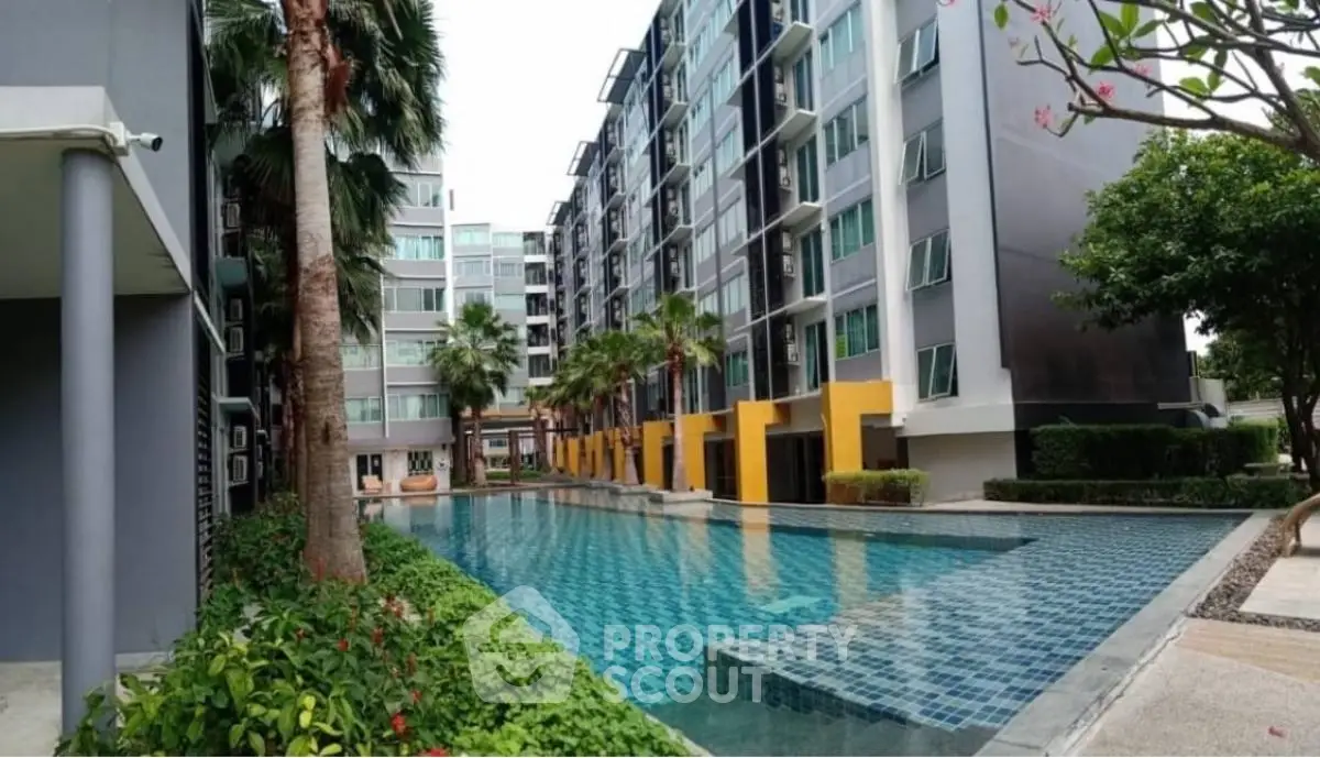 Modern condominium with pool and lush landscaping