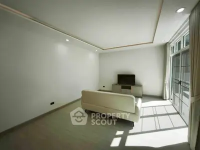 Spacious minimalist living room with natural light and modern decor