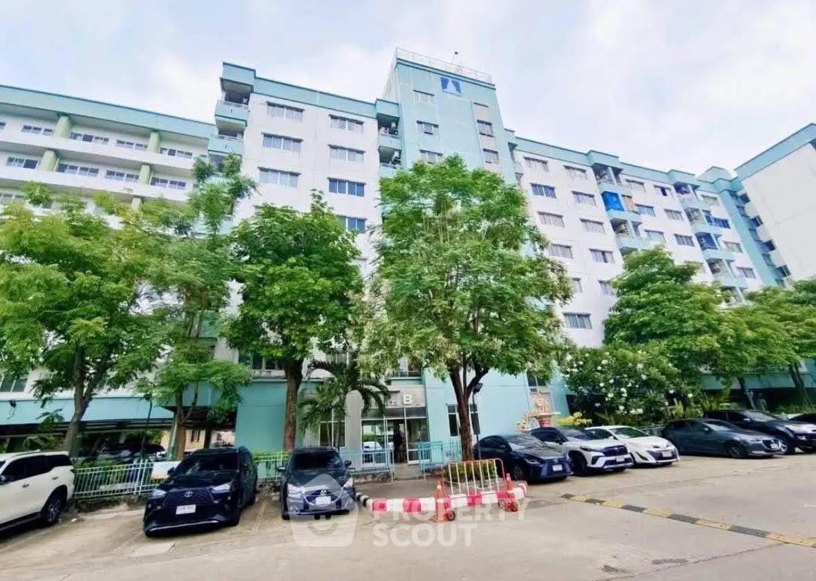 Modern residential building with parking and lush greenery
