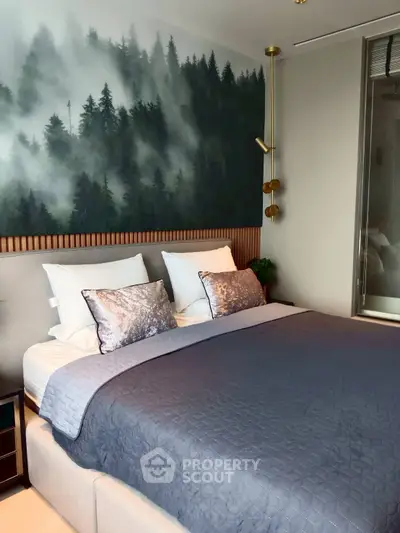 Luxurious bedroom with forest-themed wall art and elegant bedding