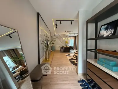 Modern open-concept living and dining area with stylish decor and elegant lighting.