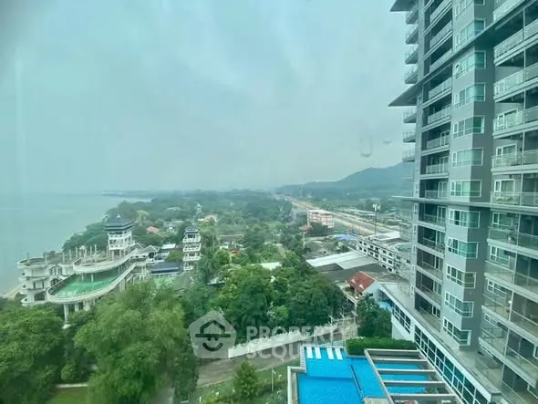 Stunning high-rise building with panoramic views of lush greenery and distant coastline.