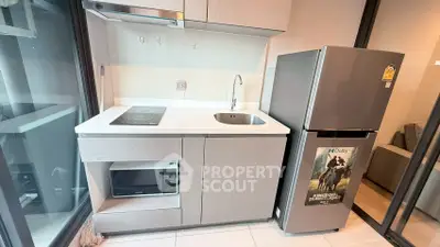 Modern compact kitchen with sleek appliances and stylish cabinetry