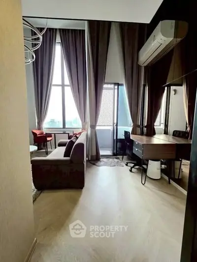 Modern living room with large windows and balcony access, featuring stylish furniture and elegant curtains.