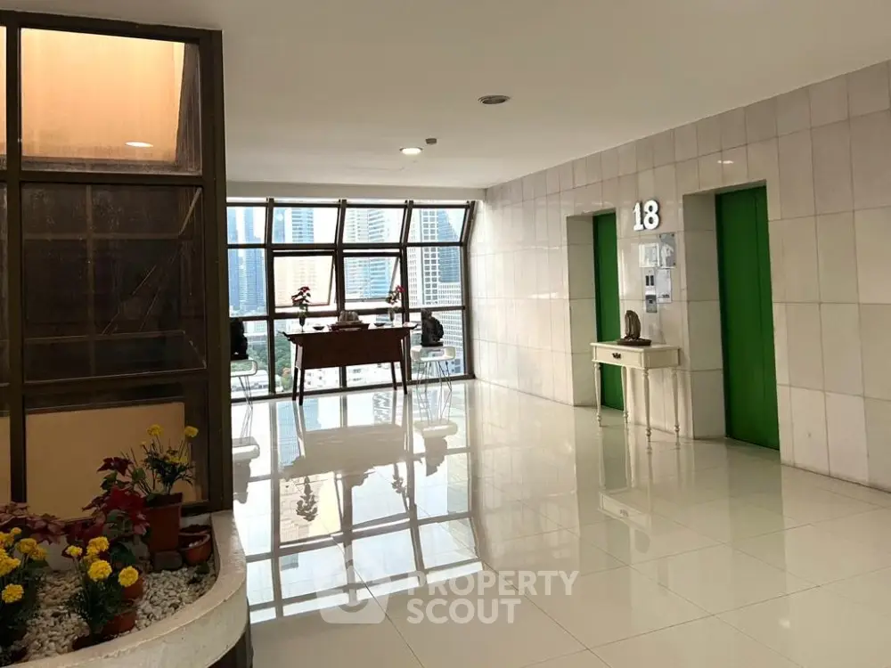 Modern elevator lobby with city view and stylish decor on the 18th floor