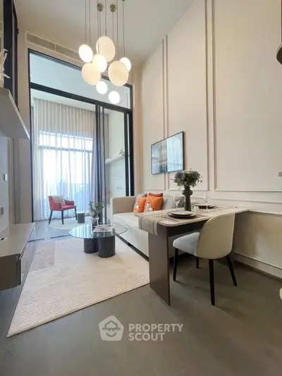 Modern living room with high ceilings and elegant decor, featuring a cozy dining area and large windows.