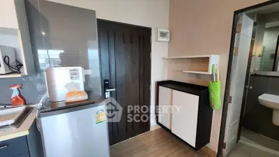 Compact kitchen area with modern appliances and storage in a cozy apartment.