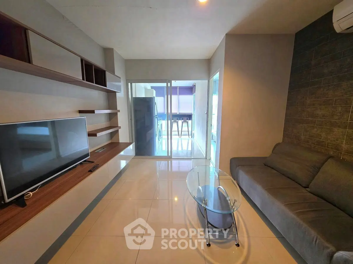Modern living room with sleek furniture and glass coffee table