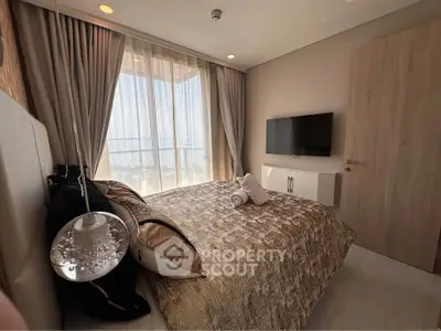 Luxurious bedroom with modern decor and large window offering stunning views