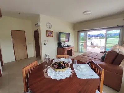 Spacious living room with dining area and large balcony view.