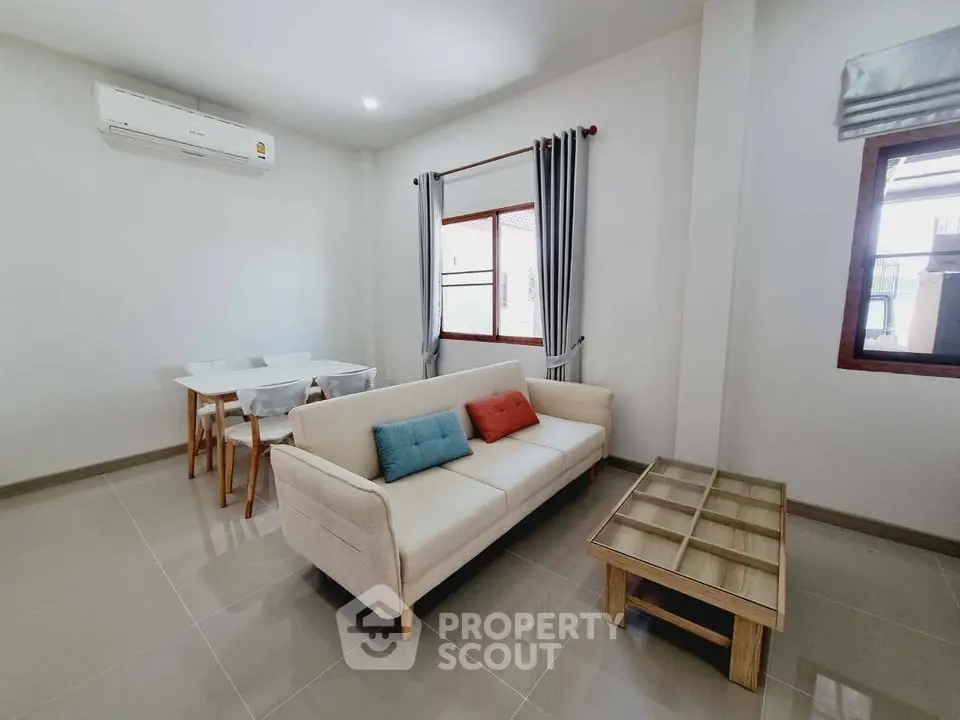 Modern living room with stylish sofa and dining area in bright apartment