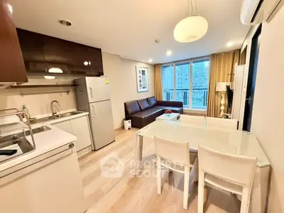 Modern open-layout living room with kitchen, dining area, and large windows in a stylish apartment.