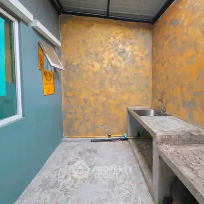 Modern outdoor kitchen with concrete countertops and unique textured walls