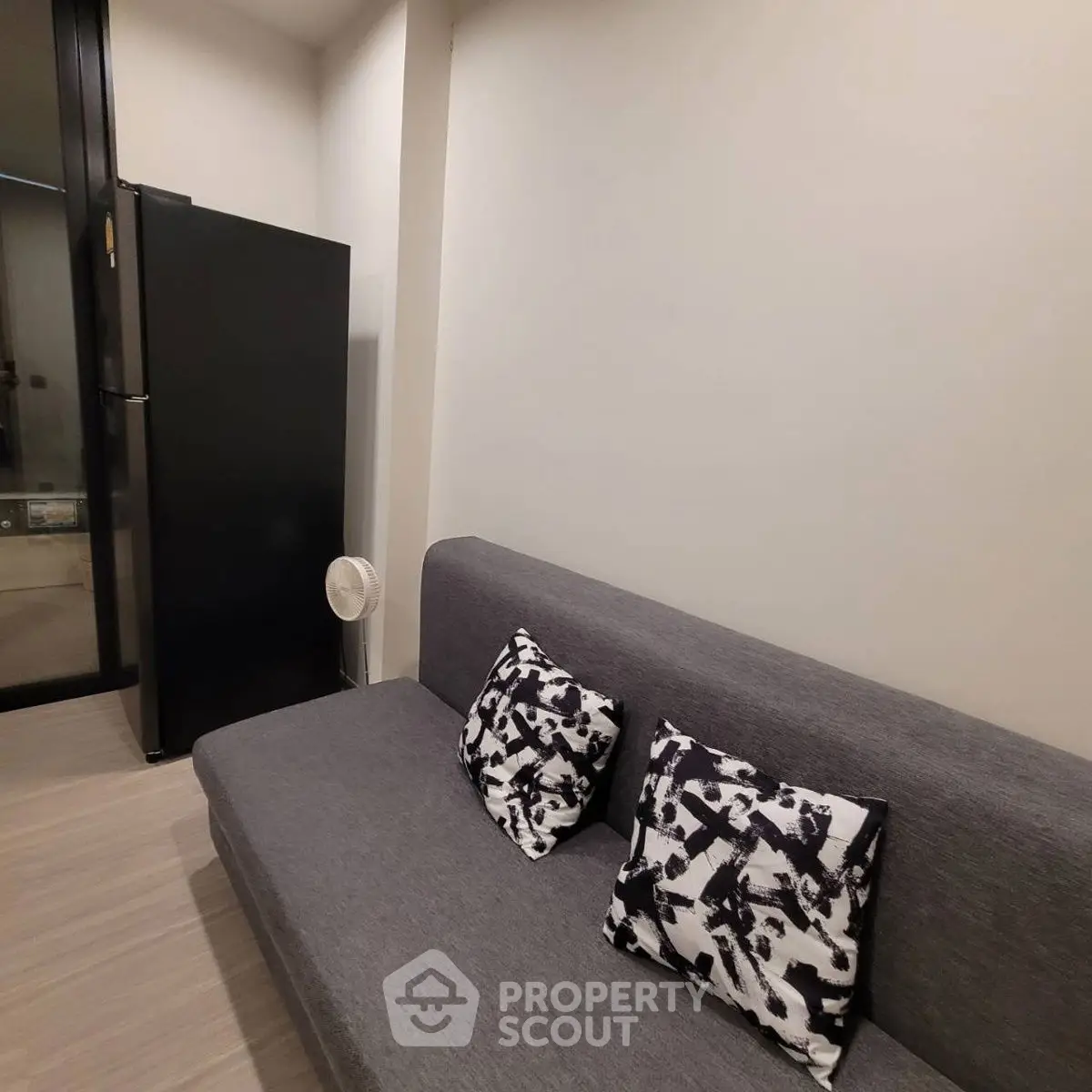 Modern living room with sleek gray sofa and stylish black and white cushions