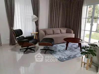 Stylish living room with modern furniture and large windows for natural light.