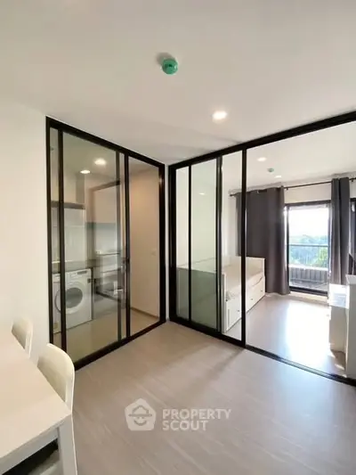 Modern apartment interior with glass partitions and natural light