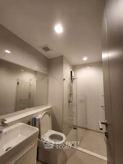 Modern bathroom with sleek fixtures and glass shower enclosure