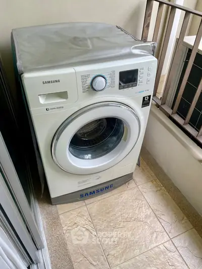 Modern washing machine on a balcony, showcasing convenient laundry setup in urban apartment.