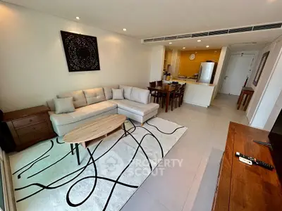 Spacious modern living room with stylish decor and open kitchen layout.