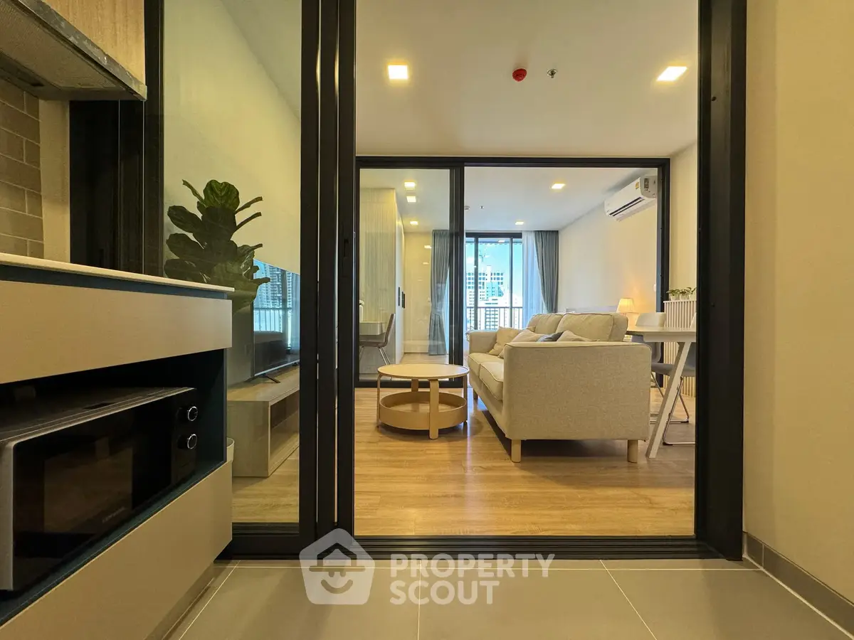 Modern living room with cozy sofa and stylish decor in open layout apartment