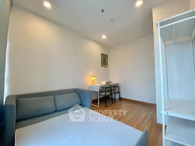 Modern minimalist living room with cozy sofa and study desk, perfect for urban living.