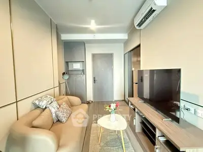 Modern living room with stylish sofa, TV unit, and air conditioning in a cozy apartment.