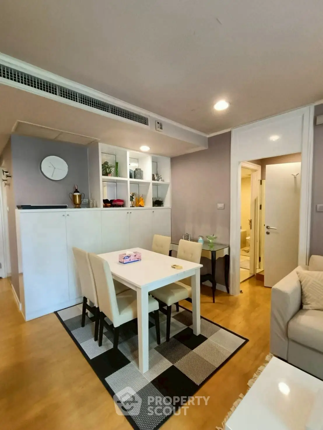 Charming dining area with modern decor and cozy seating in a stylish apartment.