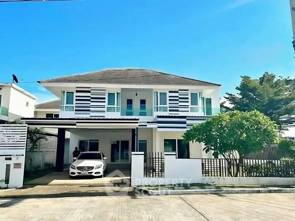 Stunning modern two-story home with sleek design and spacious driveway, perfect for luxury living.