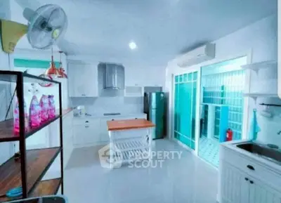 Spacious kitchen with modern appliances and open layout, featuring a sleek design and ample storage.