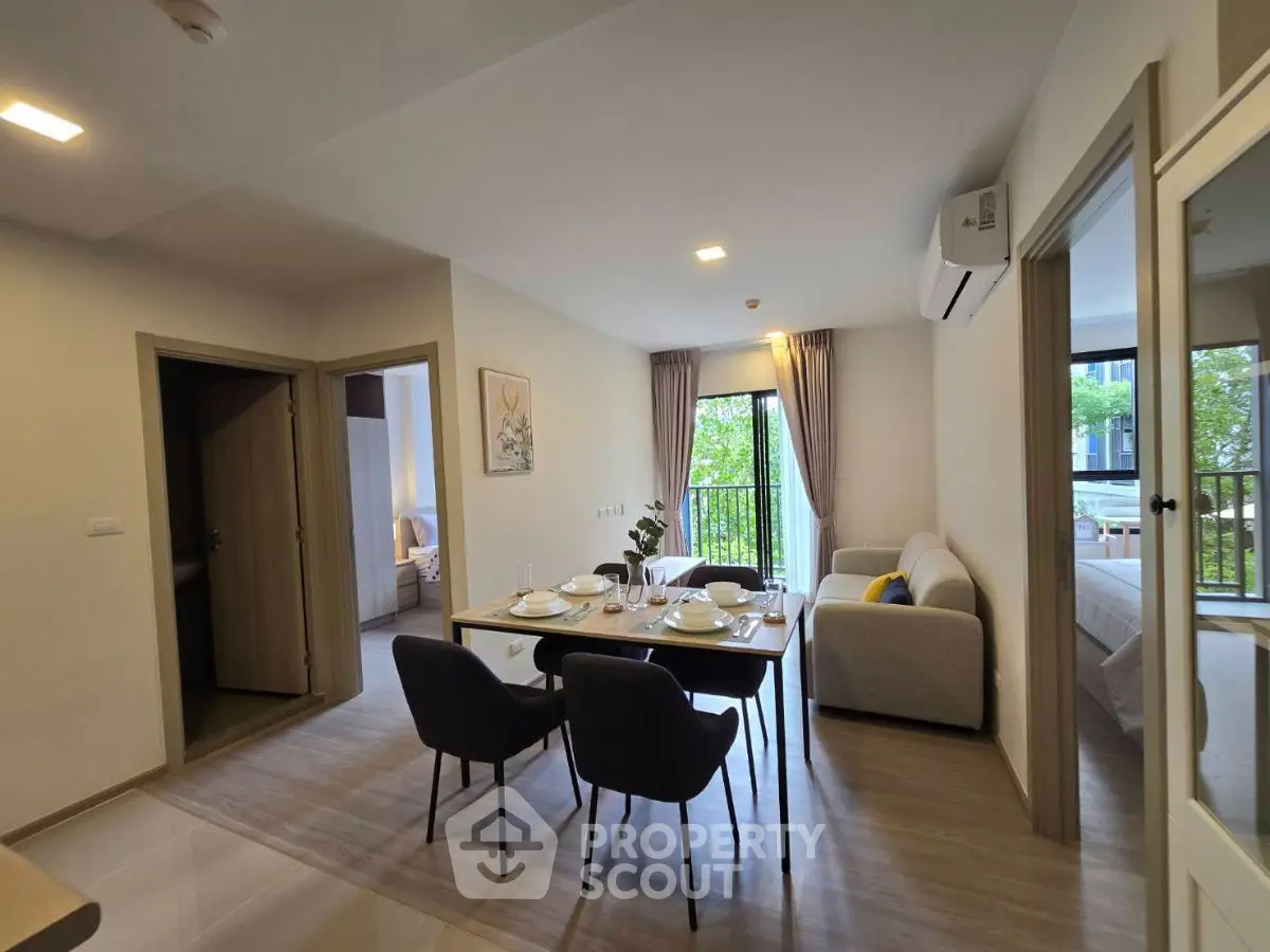 Modern apartment dining area with elegant table setting and cozy living space.