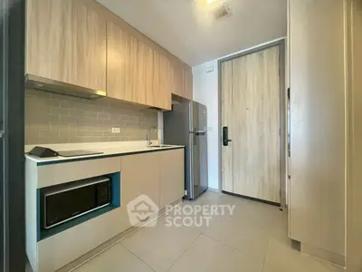 Modern kitchen with sleek cabinetry and stainless steel appliances in a compact layout.