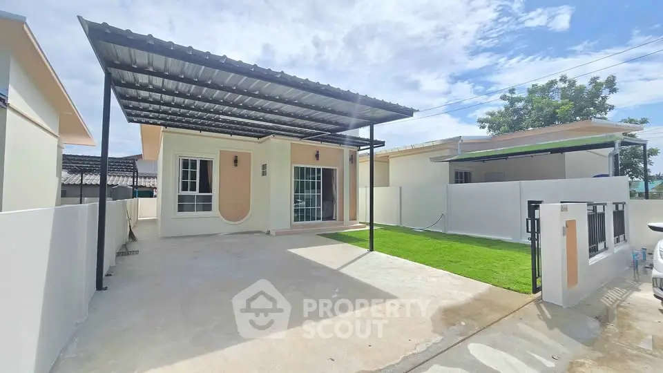 Charming single-story home with covered carport and lush green lawn, perfect for modern living.