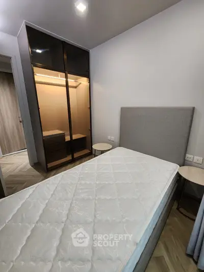 Modern bedroom with sleek wardrobe and comfortable bed in stylish apartment.