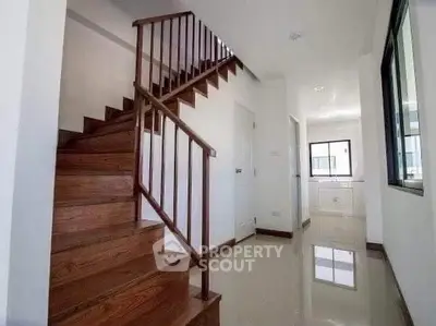 Modern interior with wooden staircase and bright hallway in a stylish home