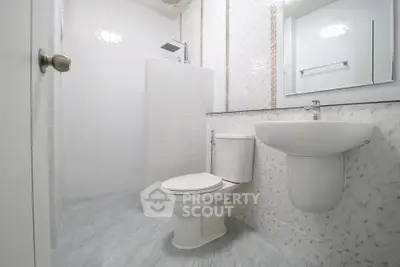 Modern bathroom with sleek white fixtures and elegant tile design