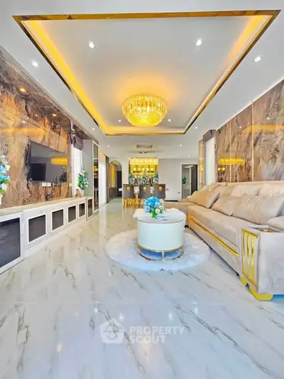 Luxurious living room with marble floors, elegant chandelier, and plush seating in a modern apartment.