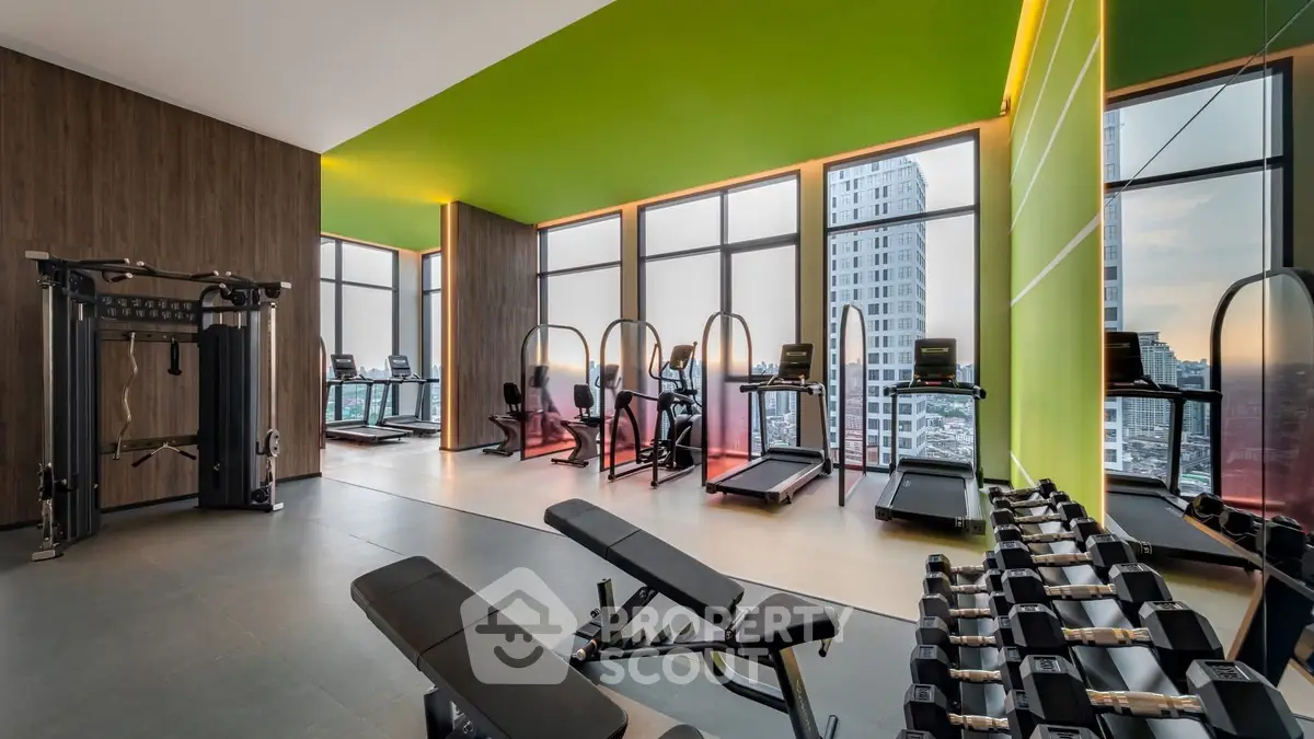 Modern gym with city view, featuring state-of-the-art equipment and vibrant green accents.