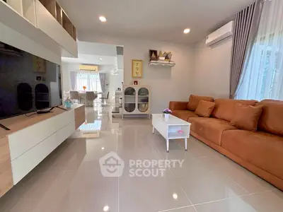 Spacious modern living room with sleek design and ample natural light, featuring a cozy sofa and stylish decor.