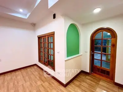 Charming interior with wooden accents and arched doorways, perfect for cozy living.