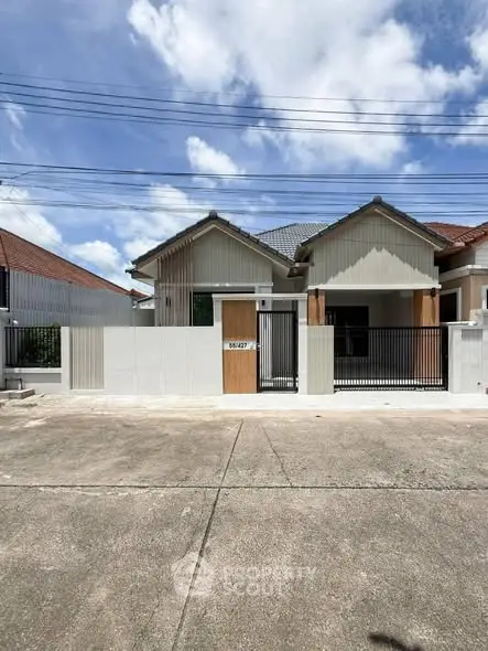 Charming single-story home with modern facade and gated entrance in a serene neighborhood.