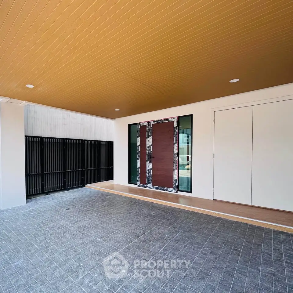 Modern building entrance with sleek design and spacious tiled area