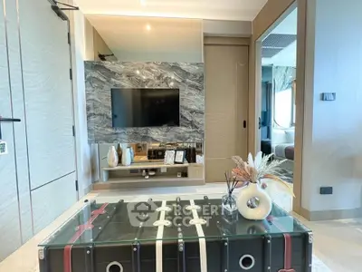 Modern living room with stylish decor and wall-mounted TV, featuring a unique coffee table and elegant accents.