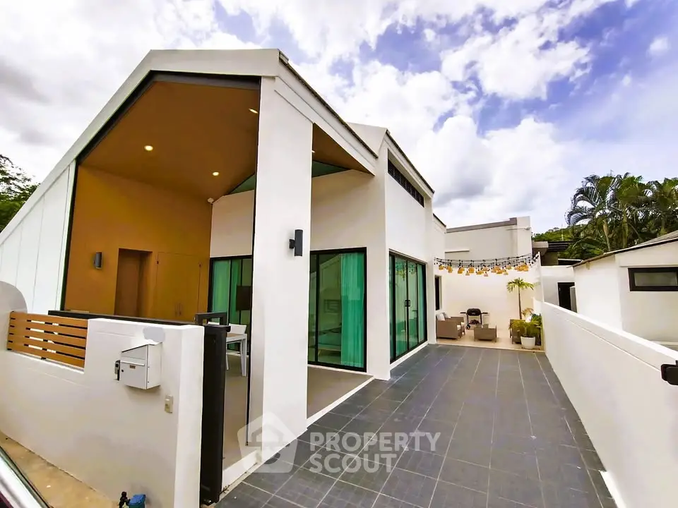 Modern minimalist home exterior with spacious patio and sleek architectural design.