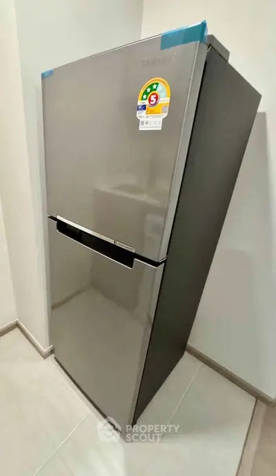 Modern stainless steel refrigerator in a sleek kitchen corner