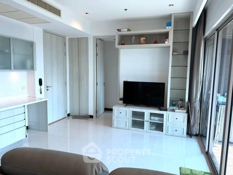 Modern living room with sleek furniture and large windows offering ample natural light.