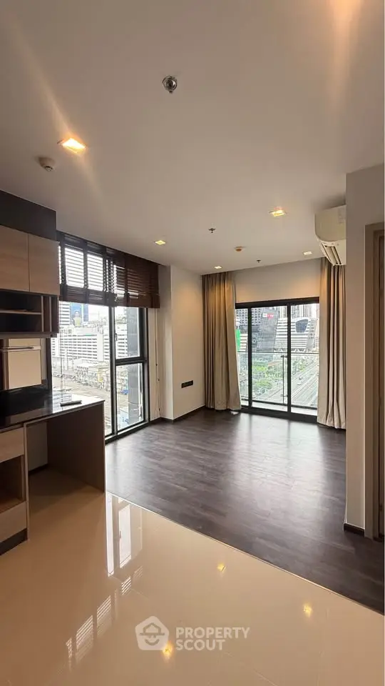 Spacious modern living room with city view and open kitchen layout