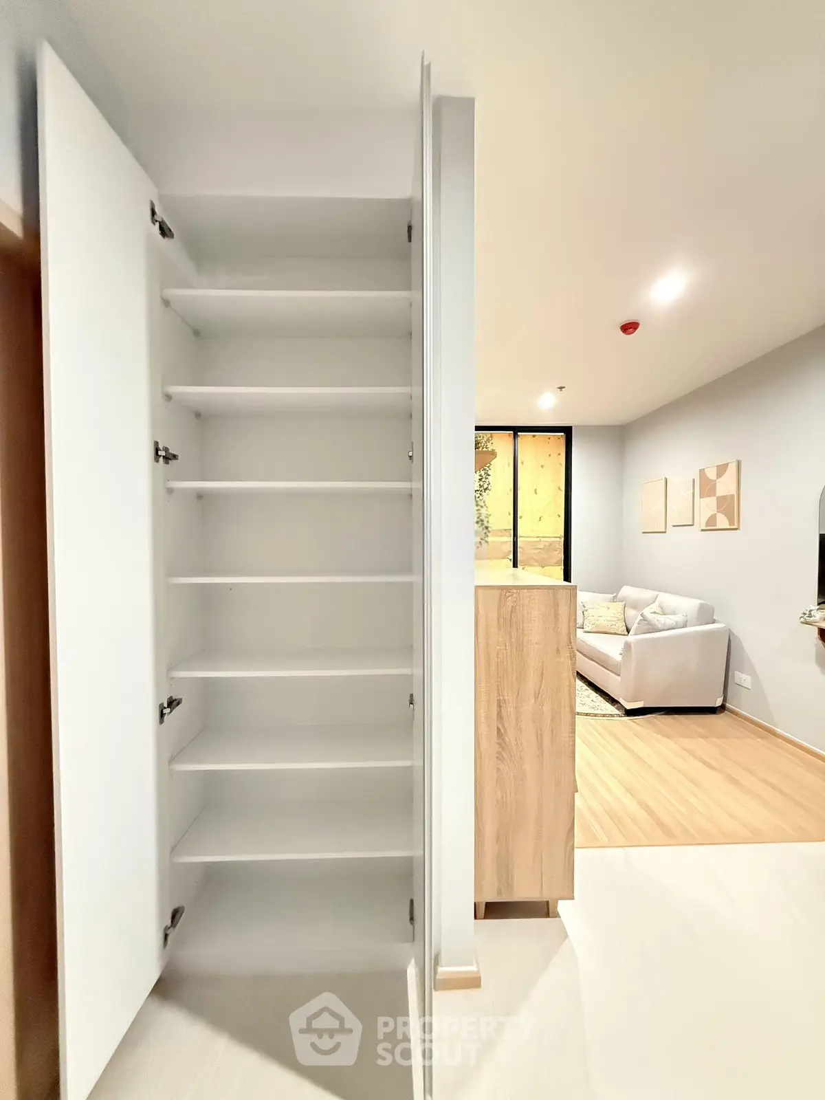 Modern apartment interior with open shelving and cozy living room