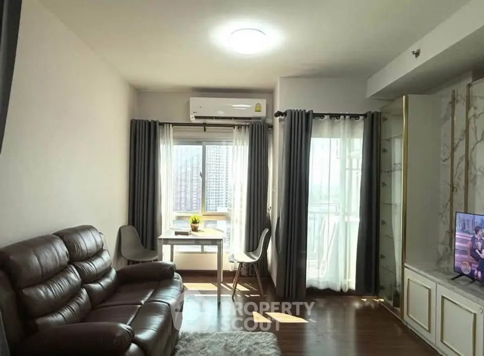 Cozy living room with leather sofa and city view, perfect for relaxation.