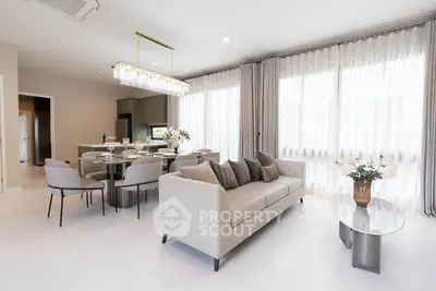 Luxurious open-plan living room with elegant decor and natural light