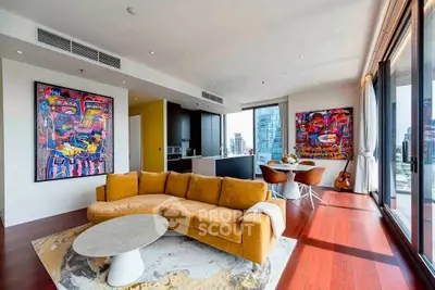 Luxurious modern living room with stunning city view and vibrant artwork.